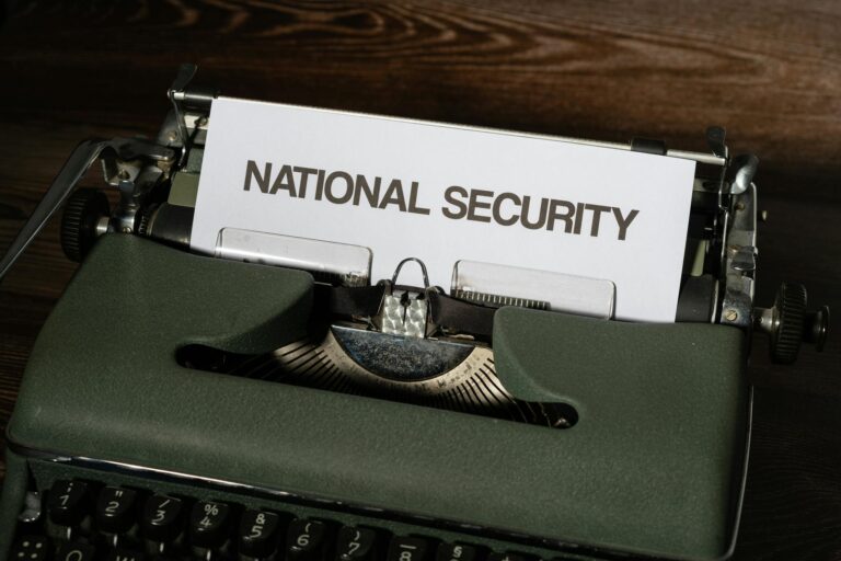 Close-up of a vintage typewriter with a paper showing the words 'National Security.'